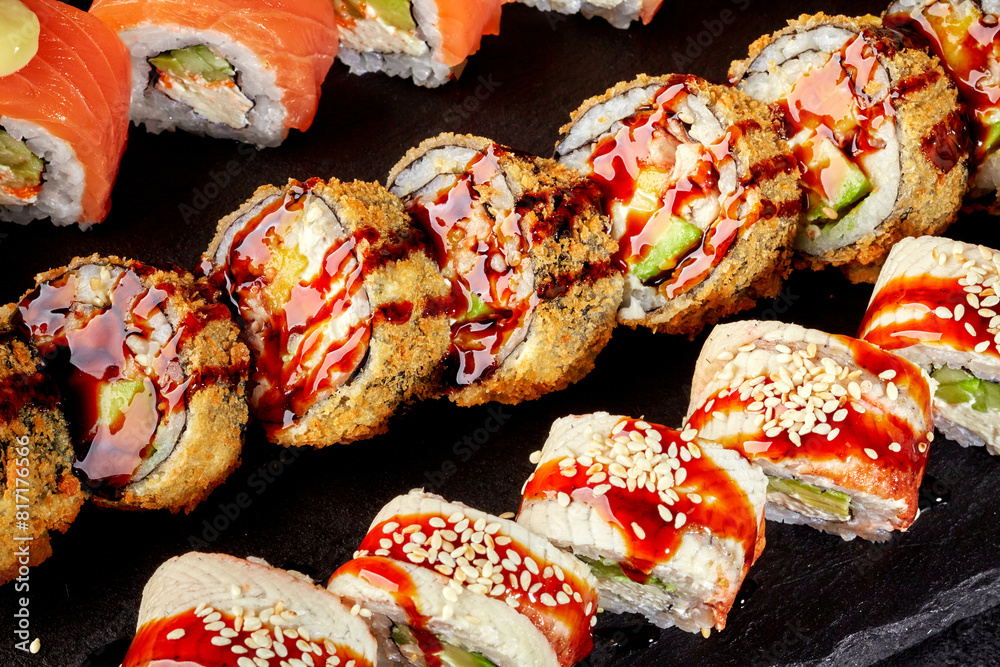 Appetizing crispy tempura rolls with ell and salmon uramaki Appetizing crispy tempura rolls with ell and salmon uramaki