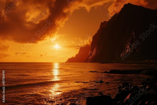 The silhouette of the needle mountain in a catalogical view from a Hawaii beach at sunset. A beautiful sky  with the sun setting behind a sharp  pointy peak.  