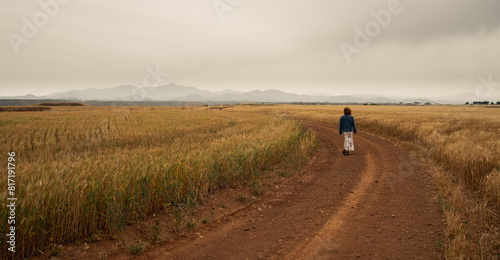Young woman walking outdoors on in a field. Hiking outdoor. Healthy lifestyle.