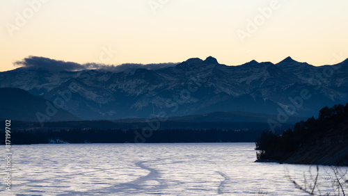Mountains over a frozen lake at sunset