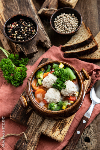 Bowl of vegetable soup with chicken meatballs