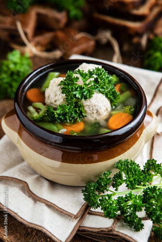 Bowl of vegetable soup with chicken meatballs