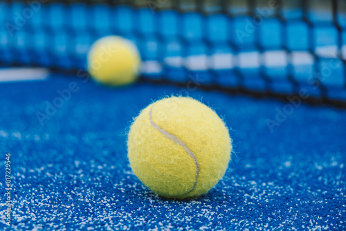 selective focus, two paddle tennis balls near the the net of a paddle tennis court © VicVaz