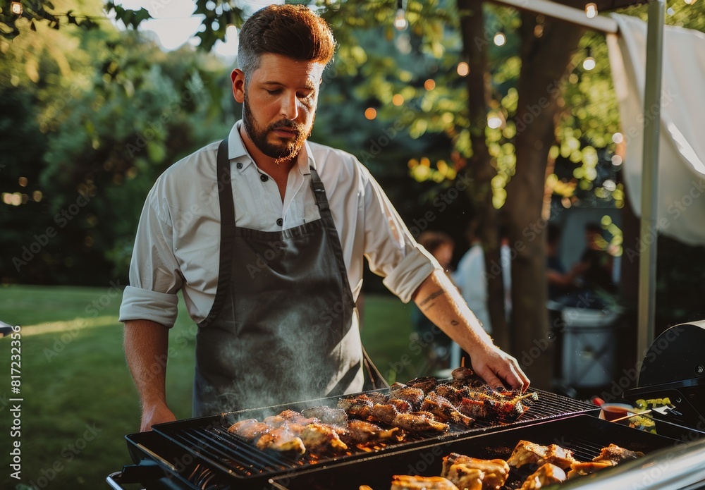 Fototapeta premium man frying meat on barbecue grill outdoors