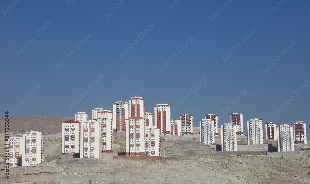 View of city buildings near a mountain of snow . City view