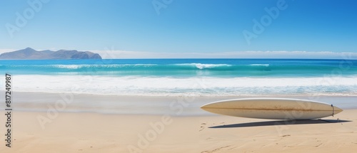 Sandy beach with a solitary surfboard © Media Srock