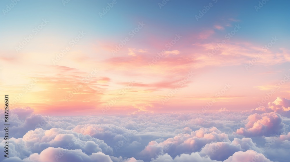 A dramatic cloudscape at sunrise with pink and golden glowing clouds against a clear blue sky A dramatic cloudscape at sunrise with pink and golden glowing clouds against a clear blue sky
