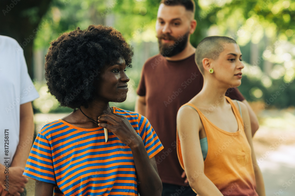 Portrait of an african american girl in a park with her friends. Portrait of an african american girl in a park with her friends.