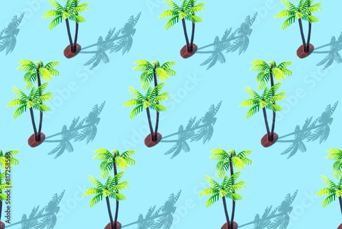Trendy sunlight summer pattern with tropical palm toy on pastel blue background. Creative minimal summer concept.