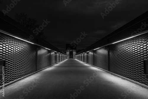 Passage to a lift in symetric architectural design illuminated in the evening photo