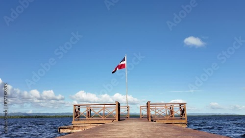 A Jetty by the Sea on Which the Flag of the Dominican Republic is Waving.