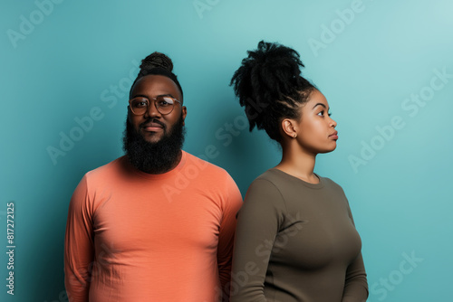 Couple in contrasting colors against teal background