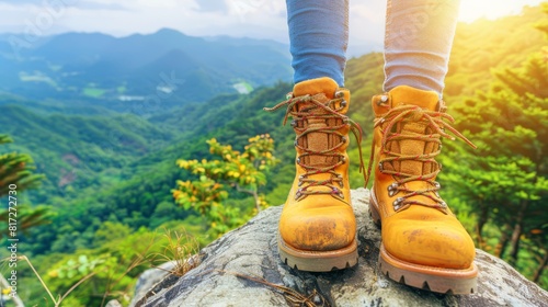  A person atop a rock wears yellow boots before a green mountain range