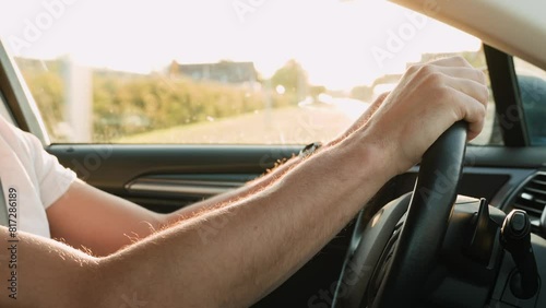 Wallpaper Mural Close up view of male driver hands on steering wheel. Man driving car at sunset. Inside view of modern vehicle moving on road Torontodigital.ca