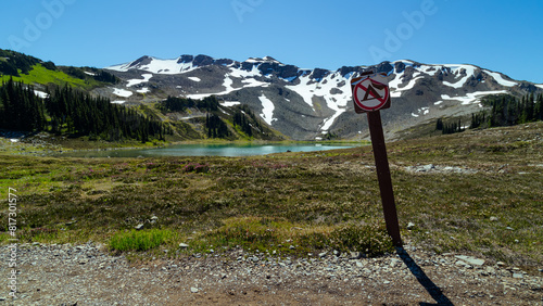 mountain with lake and no camping sign