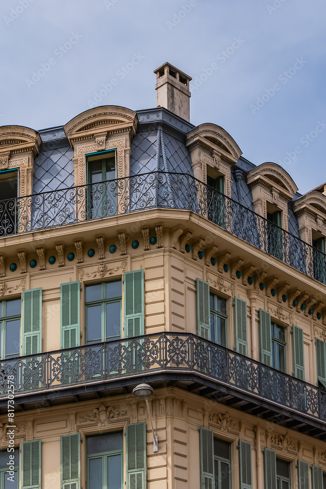 Architectural fragments of the facades of ancient houses in Nice: beautiful windows, balconies, shutters. Nice, capital of the Alpes-Maritimes department on the French Riviera.