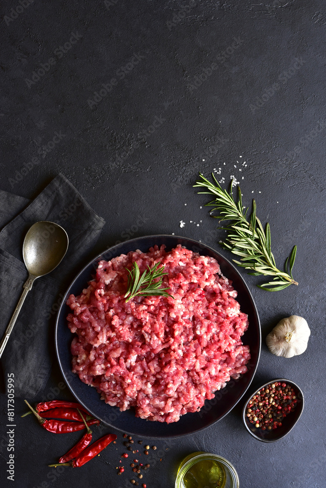 Homemade minced meat with ingredients for making in a bowl . Top view.