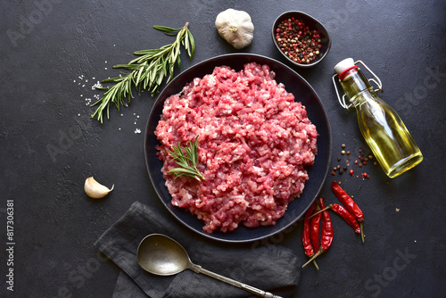 Homemade minced meat with ingredients for making in a bowl . Top view.