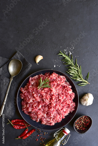 Homemade minced meat with ingredients for making in a bowl . Top view.