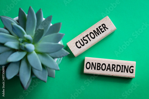 Customer Onboarding symbol. Concept word Customer Onboarding on wooden blocks. Beautiful green background with succulent plant. Business and Customer Onboarding concept. Copy space photo