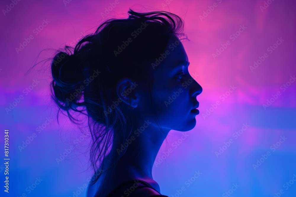 Silhouette of a person's profile with colorful neon lights background and face obscured Silhouette of a person's profile with colorful neon lights background and face obscured