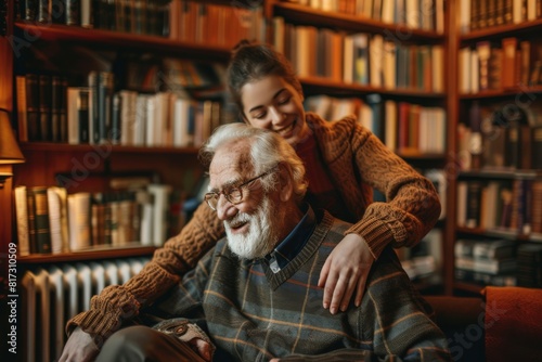 A young woman embraces her smiling elderly grandfather in a cozy library filled with books
