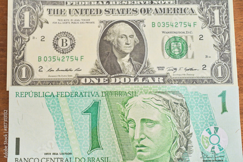 Comparison of dollar bill with brazilian real, concept of inflation or abundance photo