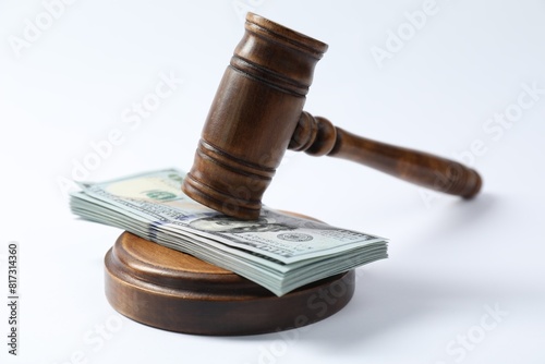 Law gavel with stack of dollars on white background photo