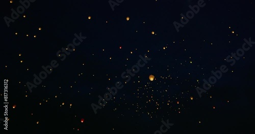 Night sky filled with hundreds of Chinese lanterns -steady cam photo