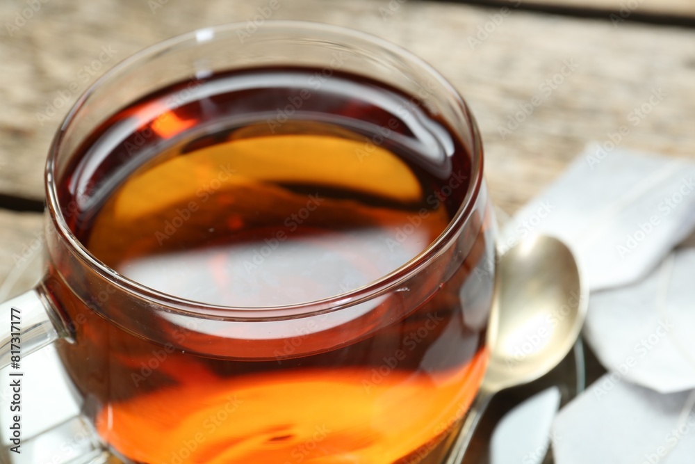 Aromatic tea in glass cup on wooden table, closeup Aromatic tea in glass cup on wooden table, closeup