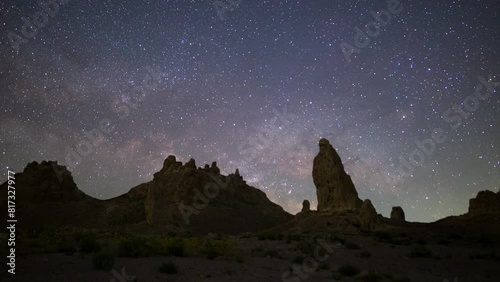 Timelapse pan of Milky Way galaxy rising over wildflower super bloom covering Trona Pinnacles in Mojave Desert in California, USA photo