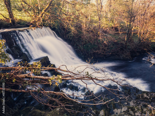 Stunning nature scene at Fowley's fall. Waterfall with blurred water. Nature background. Travel and tourism. Powerful water stream flowing in a forest.