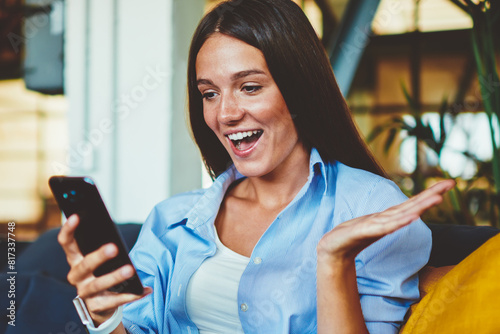 Shocked hipster girl feeling excited of watching video with impression via application on smartphone device connected to wireless 4g internet, amazed surprised woman reading news in social networks