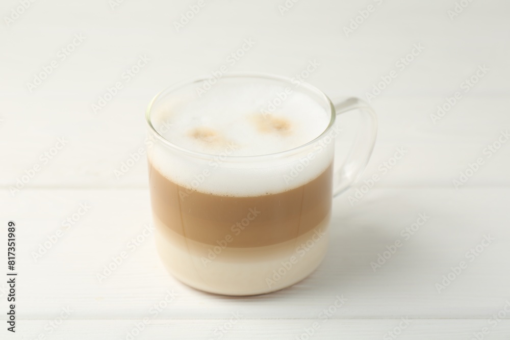 Aromatic coffee in glass cup on white wooden table, closeup Aromatic coffee in glass cup on white wooden table, closeup