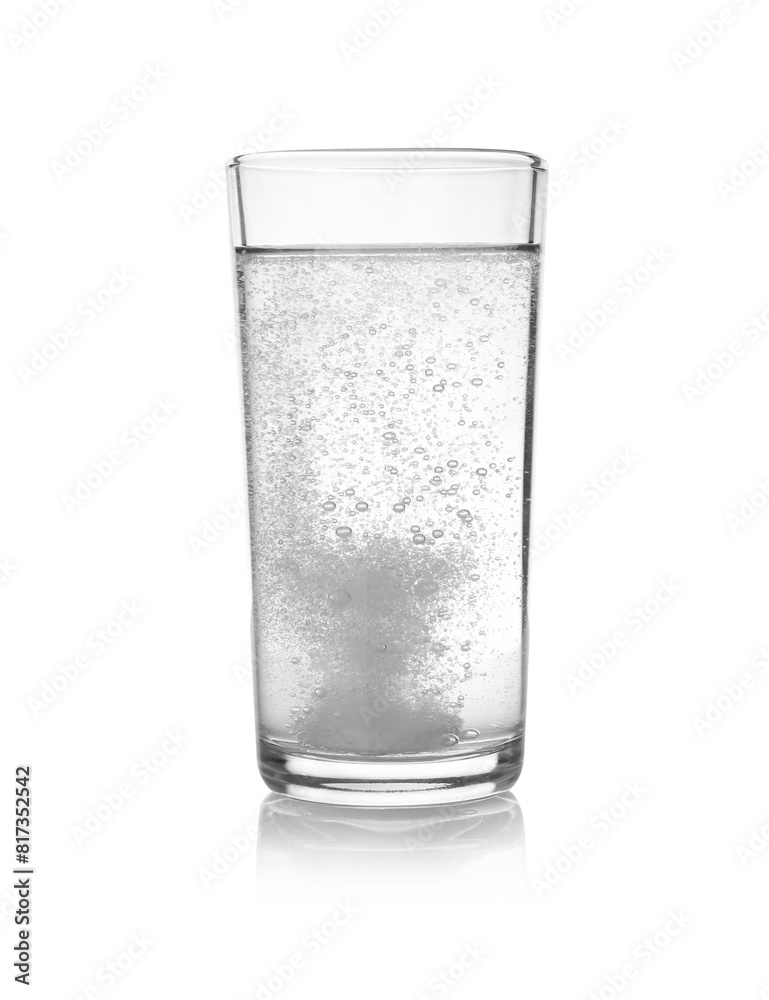 Effervescent pill dissolving in glass of water isolated on white Effervescent pill dissolving in glass of water isolated on white