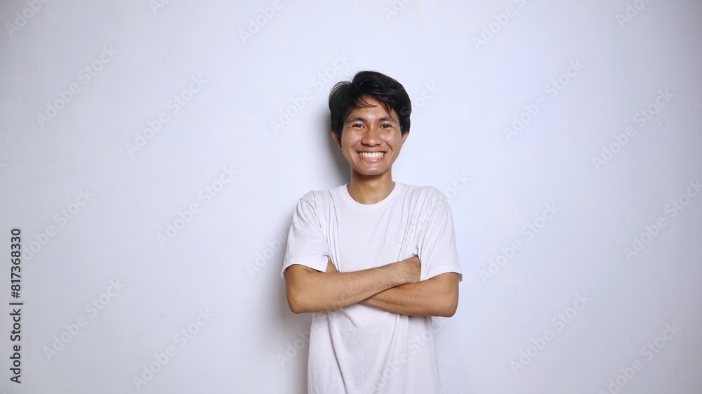 Handsome young Asian man in white shirt with crossed arms Handsome young Asian man in white shirt with crossed arms
