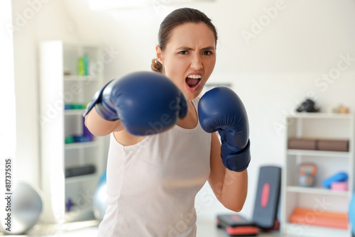 Young woman in boxing glove...