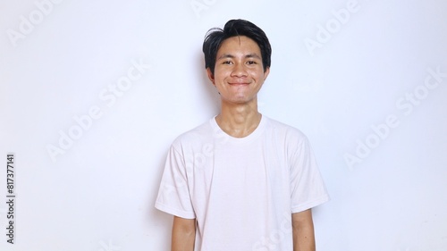 young asian man in white shirt smiling expression