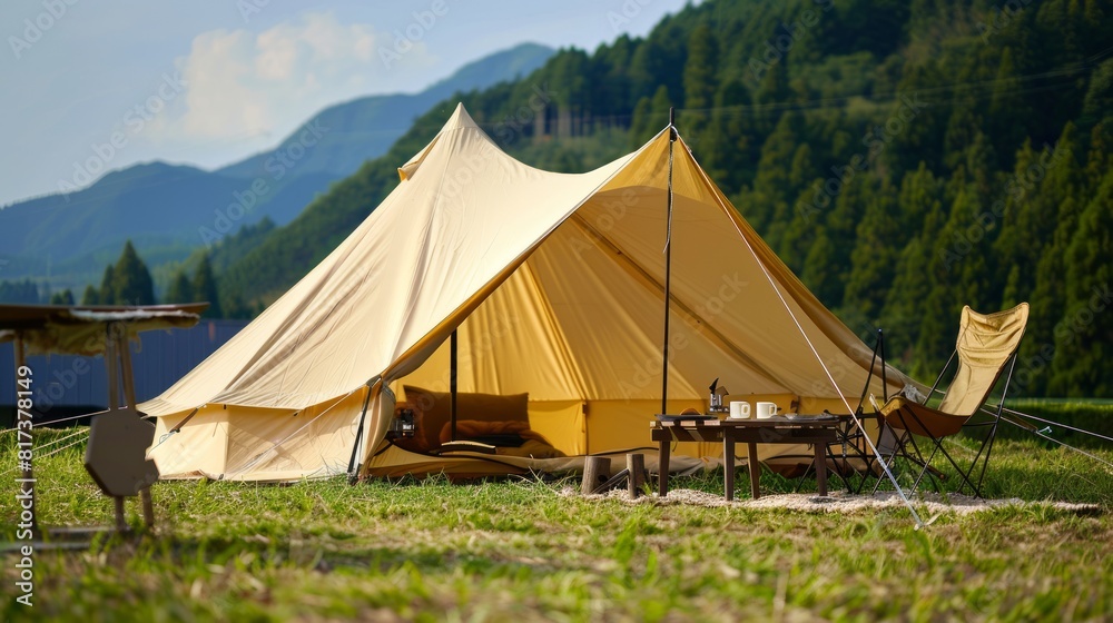 A beige canvas tent set up on the grass, with outdoor camping equipment such as folding chairs A beige canvas tent set up on the grass, with outdoor camping equipment such as folding chairs