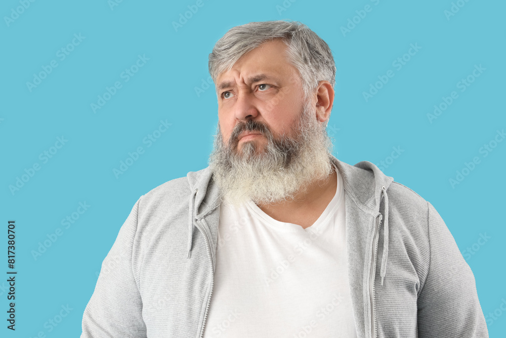 Portrait of sad senior man on blue background Portrait of sad senior man on blue background