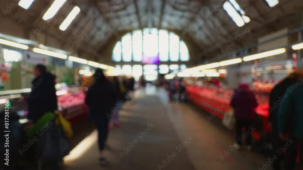 Defocused view of people wandering along a central market in Riga Defocused view of people wandering along a central market in Riga