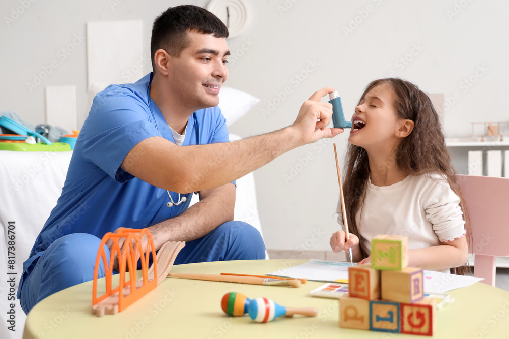 Little girl with pediatrician using inhaler in clinic Little girl with pediatrician using inhaler in clinic