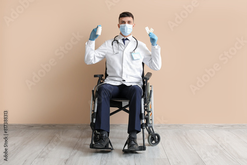 Young male doctor in wheelc...