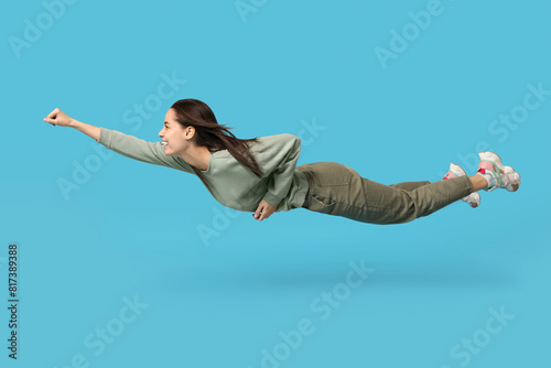 Joyful young woman flying o...