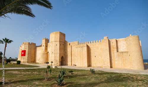 Exterior view of Ribat of Monastir, historical fortress in Tunisia, showcasing sturdy medieval Islamic architecture with high walls and strategic towers .. photo