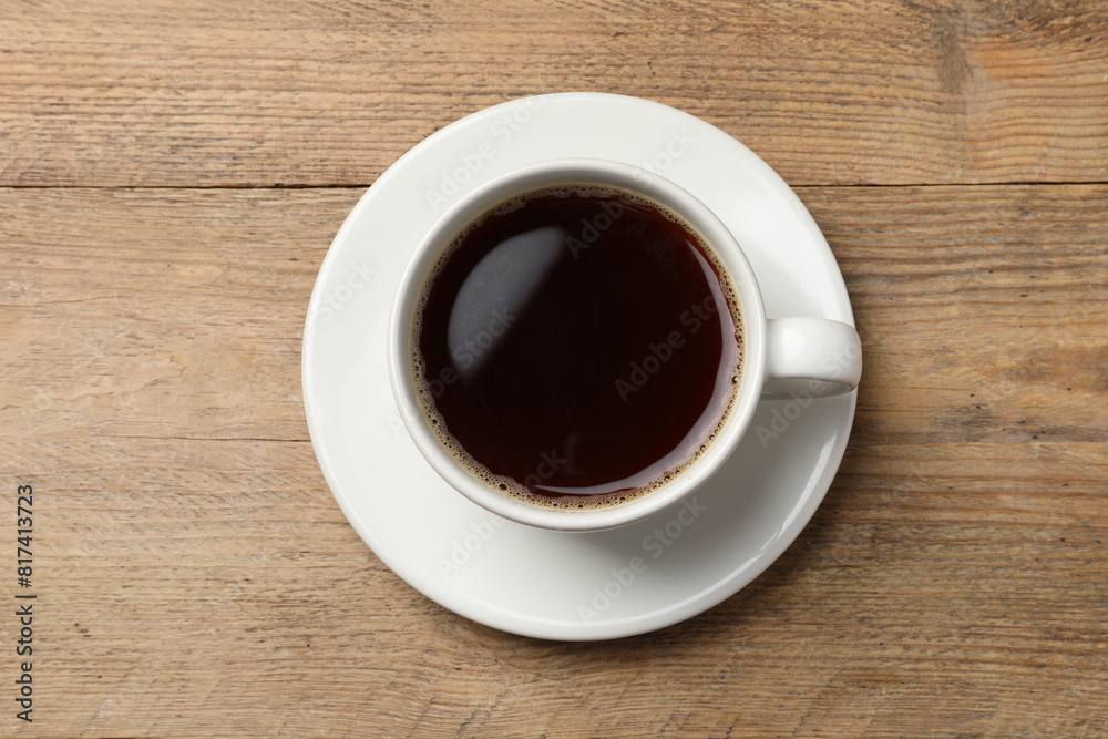 Cup of aromatic coffee on wooden table, top view. Space for text Cup of aromatic coffee on wooden table, top view. Space for text