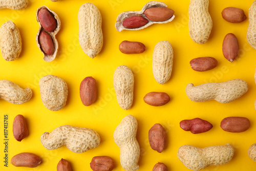 Fresh peanuts on yellow table, flat lay