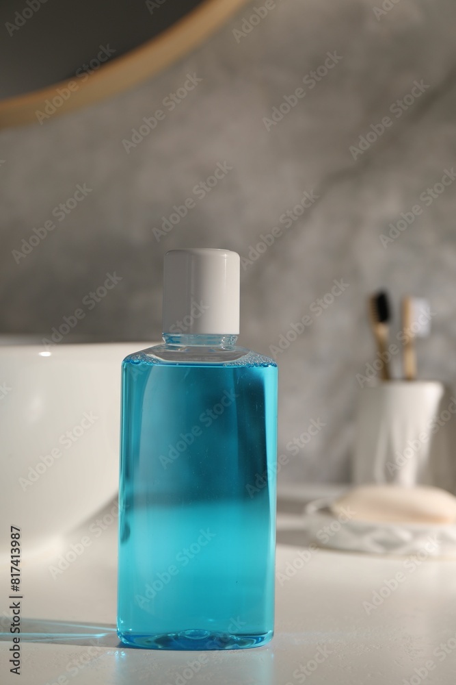 Bottle of mouthwash on light countertop in bathroom Bottle of mouthwash on light countertop in bathroom