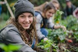 young adults smiling and planting in community garden closeup photography