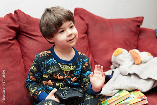 Expressive young boy in pajamas making faces